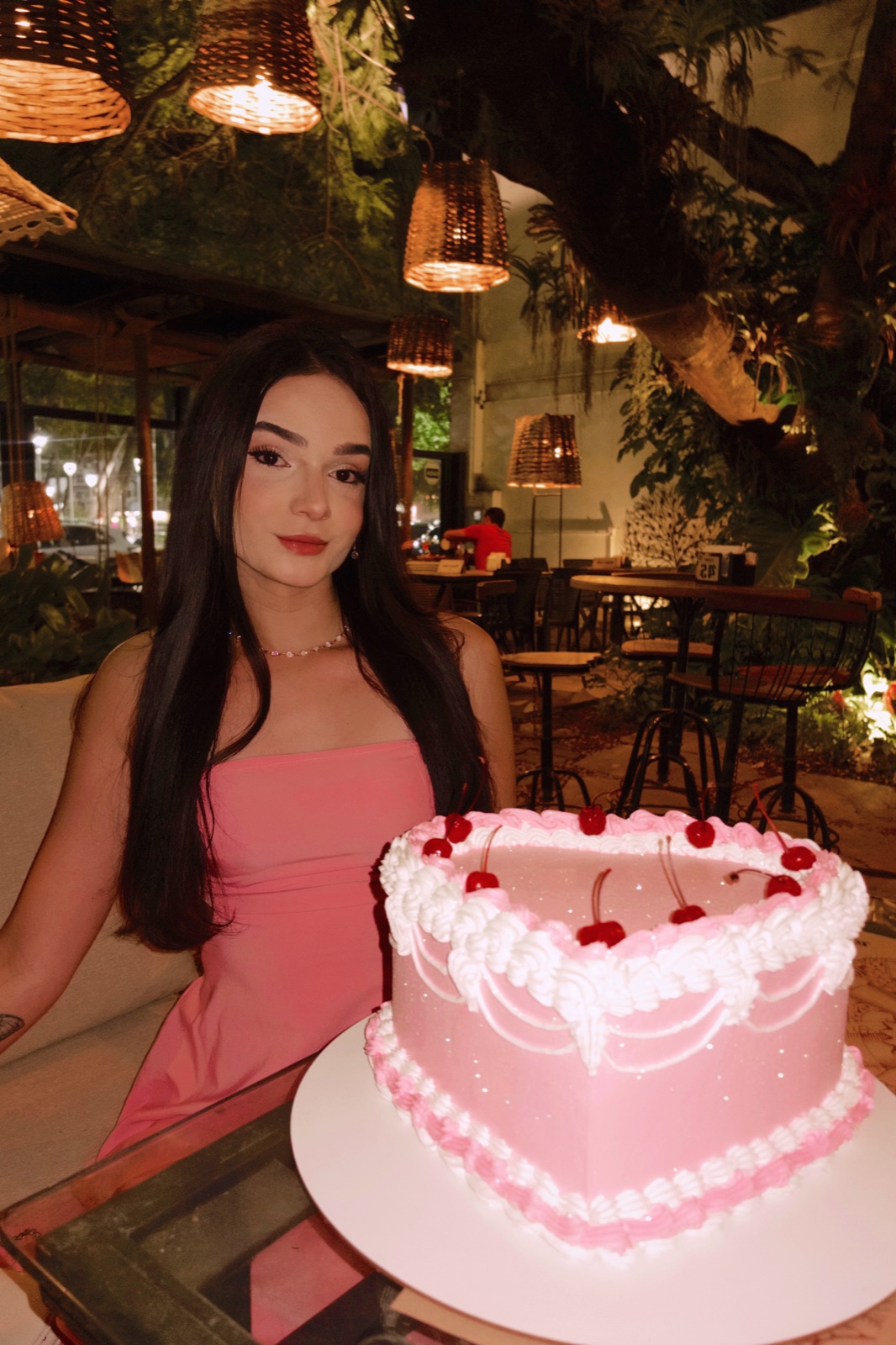 Sarah in a pink dress at a candlelit restaurant